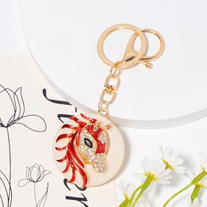 Golden horse head keychain with sparkling white rhinestones and elegant red enamel details