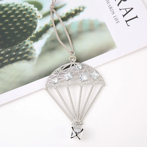 Close-up of silver hot air balloon pendant with rhinestones and a small bell detail