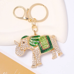 Detail of gold elephant keychain with green enamel, sparkling rhinestones and lobster clasp