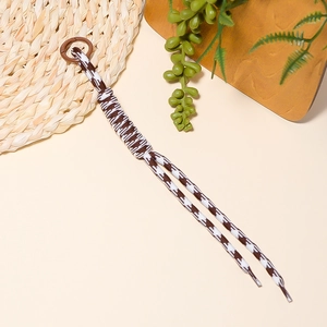 Detailed view of brown houndstooth braided phone strap with a round plastic clip