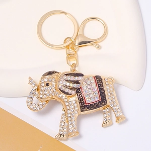 Macro detail of enamel elephant keychain with sparkling rhinestones and gold plating