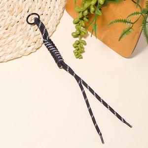 Detail of hand-woven black and white paracord keychain with a black metal ring