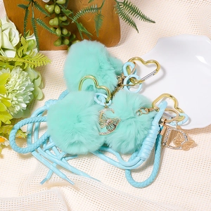 Chic mint green faux fur pompom keychain with gold heart clasp and letter charm