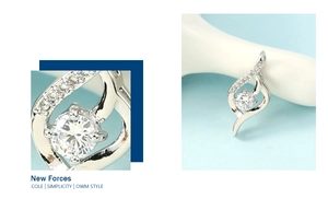 Macro detail of silver curved pendant featuring a large round zircon and side accents
