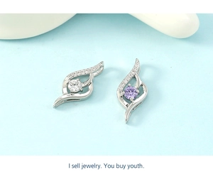 Detailed macro view of silver-finish curved pendants with purple and white stones