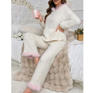 Warm women's winter pajama set with hooded rabbit ears in soft white and pink coral fleece