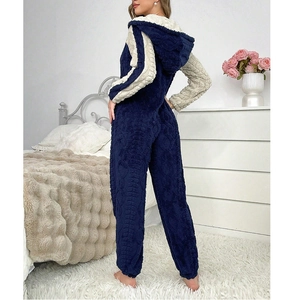 Navy and beige color block plush fleece hooded onesie for women in a cozy bedroom