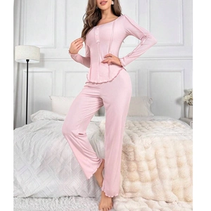 Women's soft pink pajamas set with long sleeves, round neck and ruffle trim edges