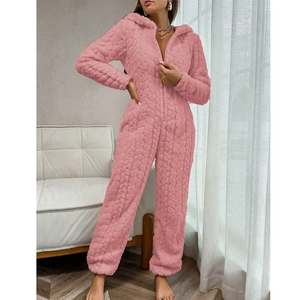 Detailed view of pink coral fleece jumpsuit showing thick cable knit texture and zipper