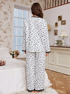 Detail of floral pajama set with delicate lace trim on the hem and soft quilted texture