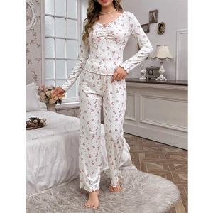 Detailed close-up of V-neck collar with pink bow and floral pattern on women's pajamas