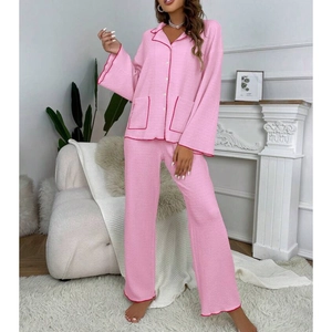 Detail of pink waffle texture pajama set with red piping and chest pockets