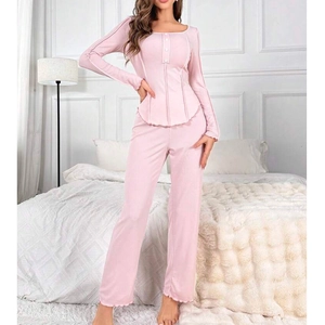 Pink ribbed pajama set for women featuring long sleeve button top and ruffled hem pants