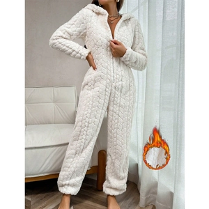 Close-up of white hooded fleece onesie showing 3D floral texture and zipper detail