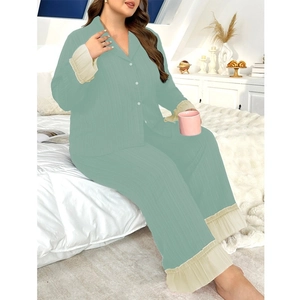 Detail of light mint green pajama set featuring pleated ruffles and button-down collar