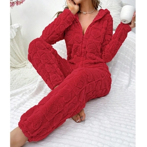 Close-up of red fleece onesie with plush heart patterns and hooded zipper detail
