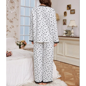 Floral quilted pajama set with black lace trim on white fabric shown from a back view