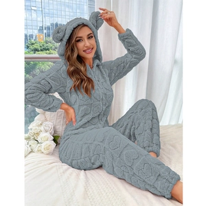 Detail of plush grey fleece onesie featuring 3D heart patterns and cute bear ears on hood
