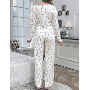 Floral pajama set with V-neck long sleeves and ruffled hem in a cozy bedroom setting