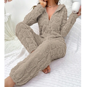 Close-up of heart embossed texture on warm coral fleece hooded jumpsuit loungewear