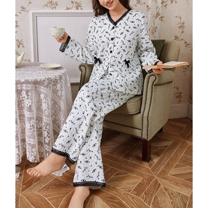 Quilted floral pajama set for women with black lace trim and bow detail in cozy home setting