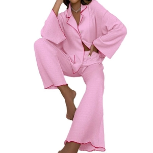 Pink women's long-sleeve pajama set with red trim and wrinkled texture fabric