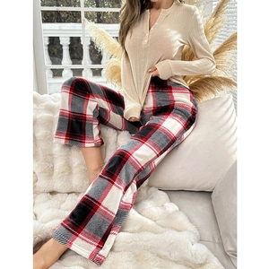 Women's pajama set featuring beige waffle knit long sleeve top and red plaid flannel pants