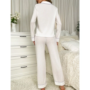 White waffle knit pajamas set with purple trim featuring long sleeve top and pants
