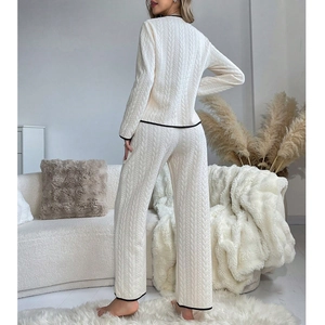 Women's two-piece cable knit pajama set in cream with elegant black contrast piping
