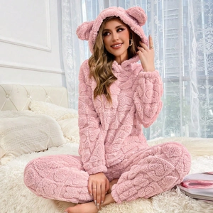 Detailed texture of pink plush hooded loungewear featuring cute 3D bear ears on hood