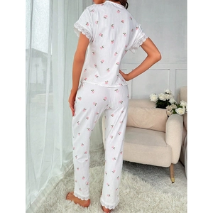 Women's two-piece floral pajama set with white lace trim and pink flower patterns