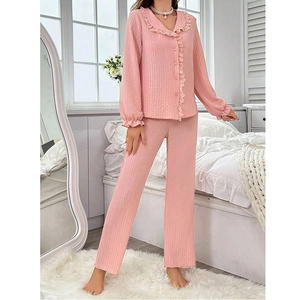Detail of light pink pajama set showing ruffle collar and textured waffle fabric