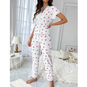 Detail of V-neck cherry print pajamas with lace trim and vertical ribbed knit texture