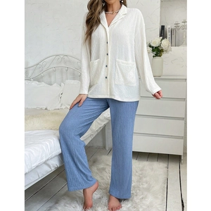 Women's two-piece pajama set with white pleated button-up shirt and blue trousers