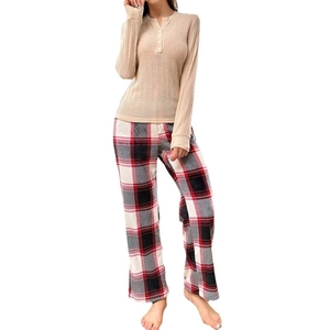 Women's crewneck long-sleeve pajama set with beige ribbed top and red plaid pants