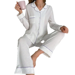 White waffle knit pajama set with purple trim, button-down long sleeves and trousers