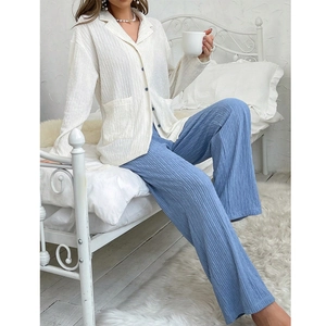 Close-up of white pleated button-down top and blue wide-leg pants loungewear set