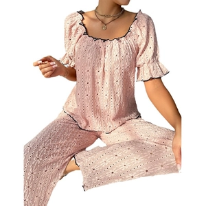 Pink two-piece lace pajama set with short sleeves, long pants, and black contrast trim