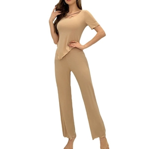 Women's chic ribbed knit lounge set featuring irregular hem top and straight-leg trousers