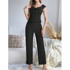 Detail of black V-neck lace loungewear set featuring ribbed texture and decorative bow