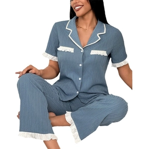 Women's pajama set featuring short sleeve lapel top and pants with white ruffled trim