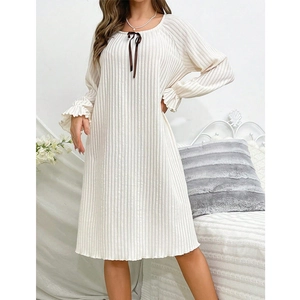 Detail of cream long sleeve nightgown with brown bow and ruffled rib cuffs