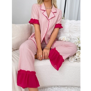 Pink short sleeve pajama set with contrasting magenta lace trim on ruffled edges