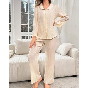 Women's cream button-up pajama set with textured vertical stripes and ruffle sleeves