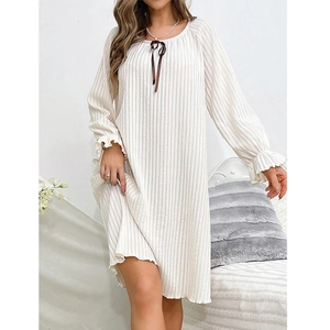 Detail of sweet bow tie neckline and ribbed texture on beige long-sleeve nightdress