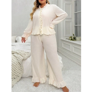 Close-up of cream white ribbed fabric loungewear set with ruffled edges and V-neckline