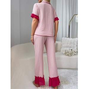 Women's pink pleated pajama set with vibrant rose red ruffled edges and buttons