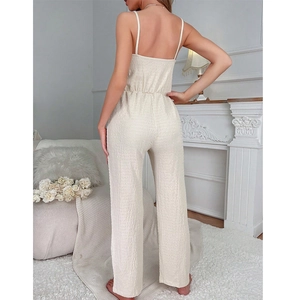 Elegant V-neck backless jumpsuit in beige textured fabric with a high-waisted straight cut