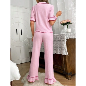 Pink short sleeve loungewear set with red ruffled edges shown from a back view