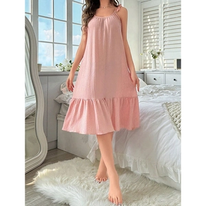 Detail of light pink sleeveless nightgown featuring lettuce trim and pleated fabric texture